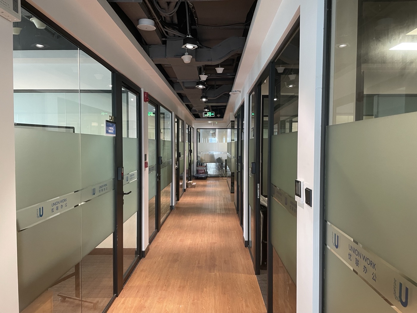 Office hallway and collaboration-space entrance.